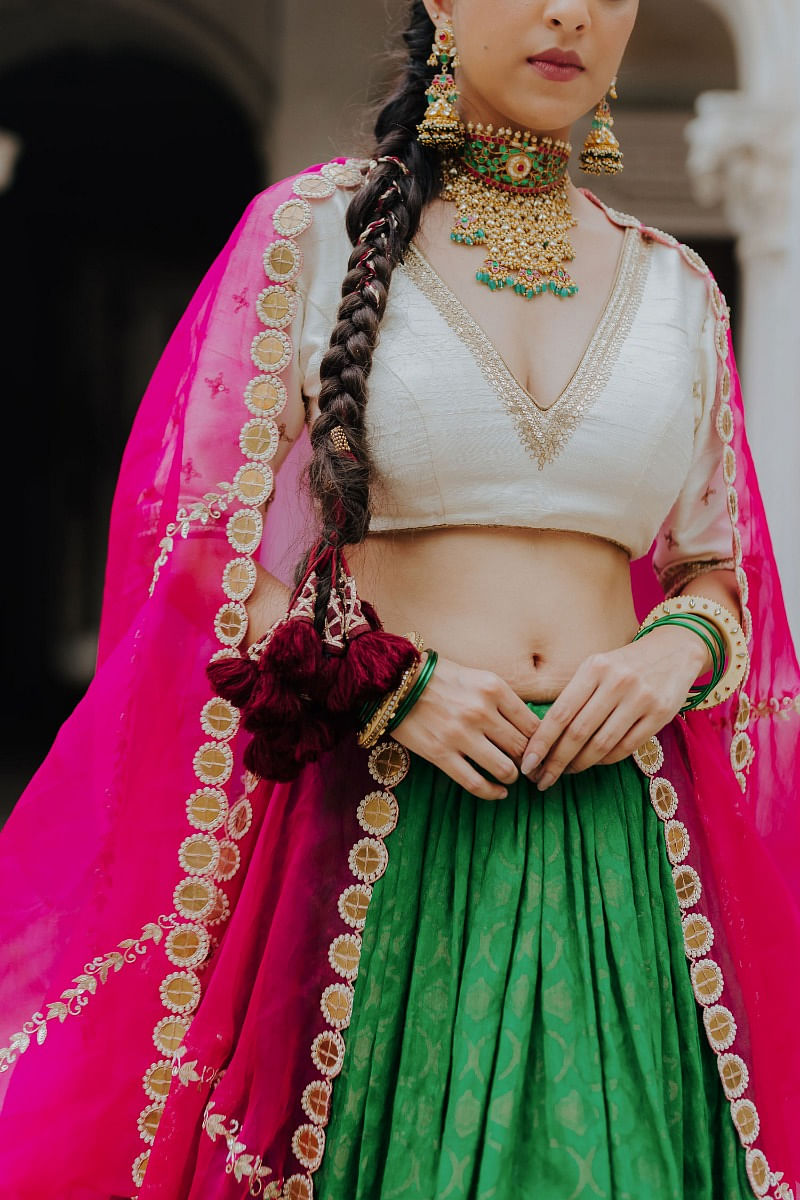 Photo of Dark green bridal jewellery with light pink lehenga