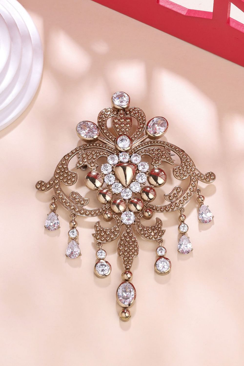 Gold and white glass stone brooch