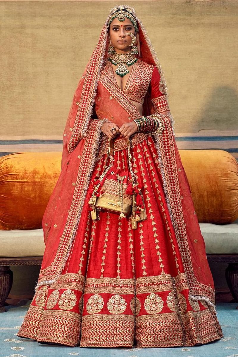 Red lehenga set with two tissue dupattas designed by Sabyasachi at AASHNI+CO.